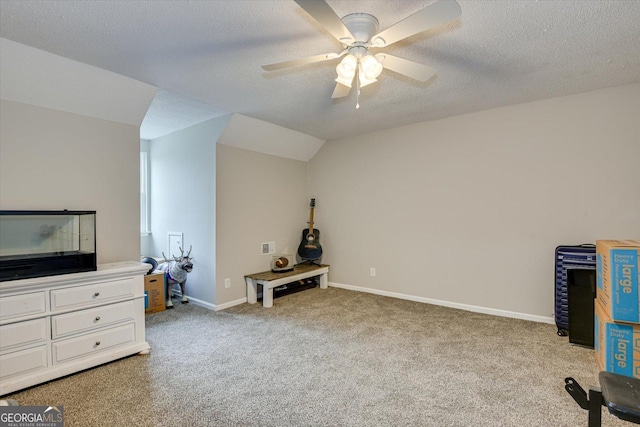 interior space featuring a textured ceiling, light carpet, lofted ceiling, and ceiling fan