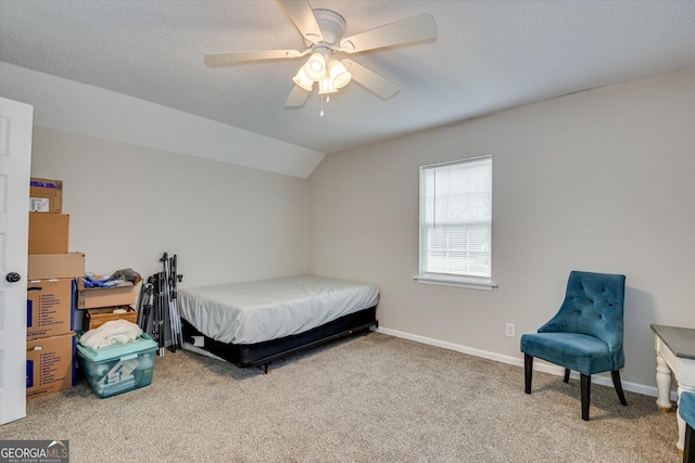 bedroom with a textured ceiling, lofted ceiling, carpet flooring, and ceiling fan