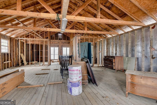 misc room featuring plenty of natural light, vaulted ceiling, and hardwood / wood-style floors