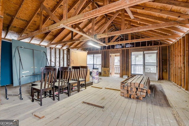 misc room with hardwood / wood-style flooring, vaulted ceiling, and a healthy amount of sunlight