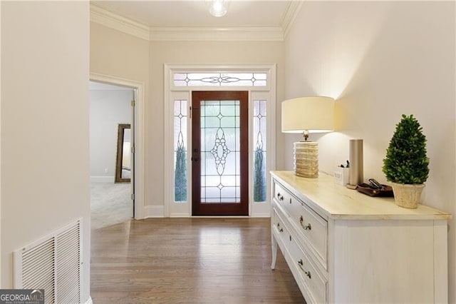 foyer entrance featuring wood-type flooring and crown molding