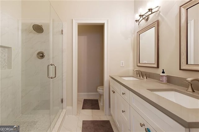 bathroom with vanity, toilet, and a shower with shower door