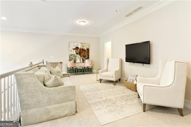 sitting room with crown molding and carpet flooring