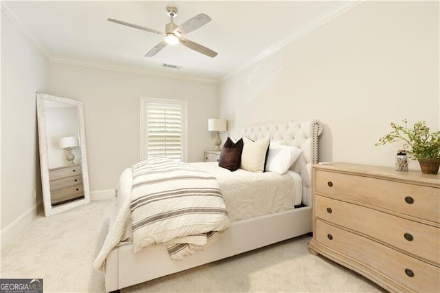 carpeted bedroom with ceiling fan and crown molding