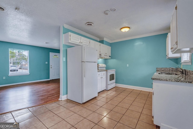 107 Overland Trl, Savannah, GA 31419 - kitchen featuring white appliances, under cabinet range hood, a textured ceiling, white cabinets, and light stone countertops