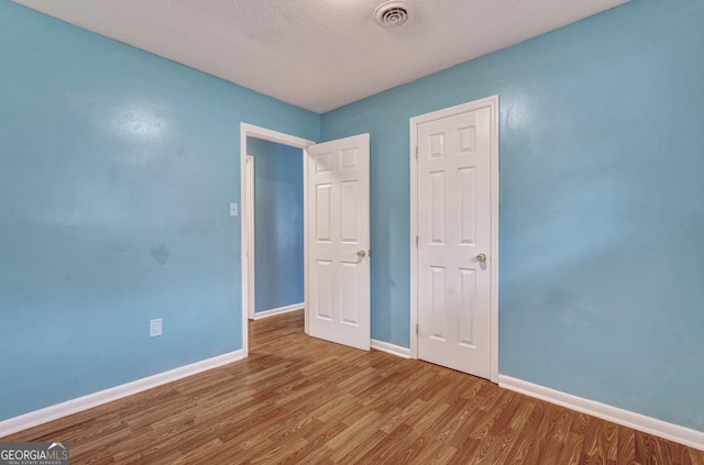 107 Overland Trl, Savannah, GA 31419 - empty room with wood finished floors and a textured ceiling
