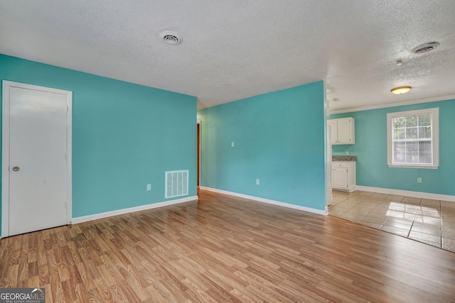 107 Overland Trl, Savannah, GA 31419 - empty room with a textured ceiling and light wood-type flooring