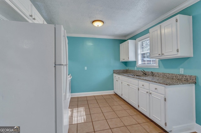 107 Overland Trl, Savannah, GA 31419 - kitchen with freestanding refrigerator, white cabinetry, a textured ceiling, crown molding, and stone countertops