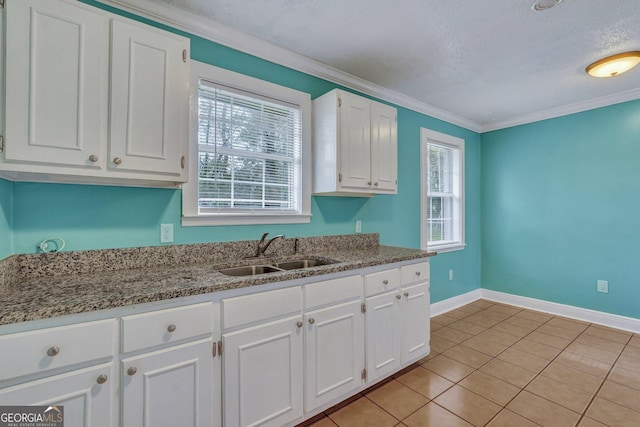 107 Overland Trl, Savannah, GA 31419 - kitchen with white cabinets, ornamental molding, light tile patterned floors, stone counters, and a textured ceiling