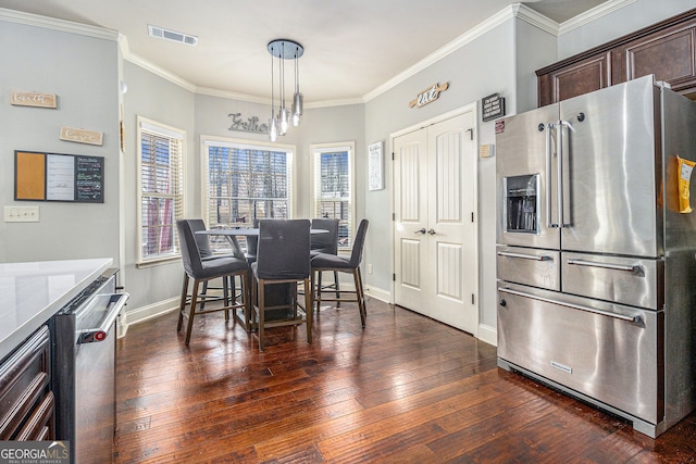 dining area with ornamental molding, dark wood-style flooring, visible vents, and baseboards