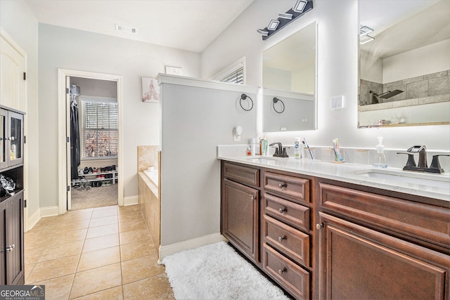 full bathroom with double vanity, visible vents, a sink, and tile patterned floors