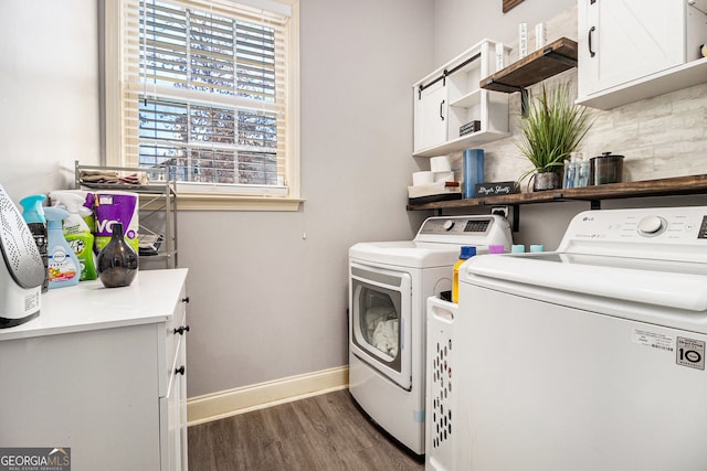 laundry room with baseboards, dark wood finished floors, cabinet space, and washer and dryer