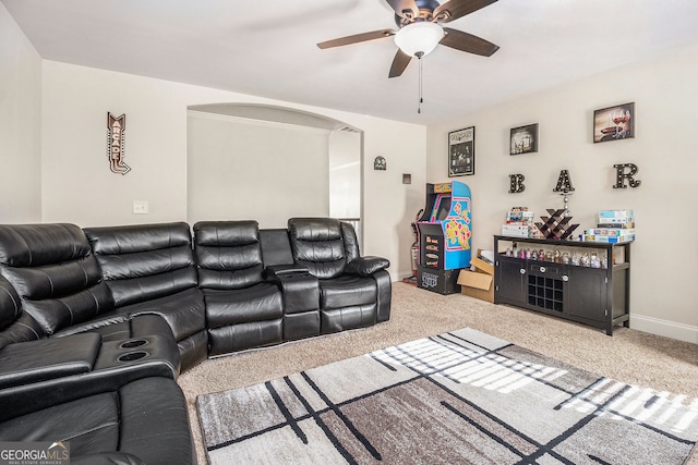 224 Jester Ct, Mcdonough, GA 30252 - carpeted living room with baseboards, arched walkways, ceiling fan, and a bar