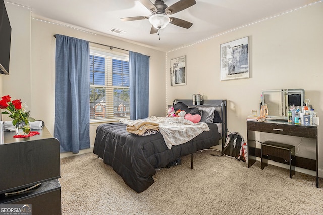 224 Jester Ct, Mcdonough, GA 30252 - carpeted bedroom featuring ornamental molding, a ceiling fan, and visible vents