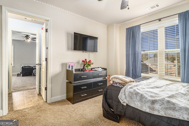 bedroom with visible vents, light carpet, and baseboards