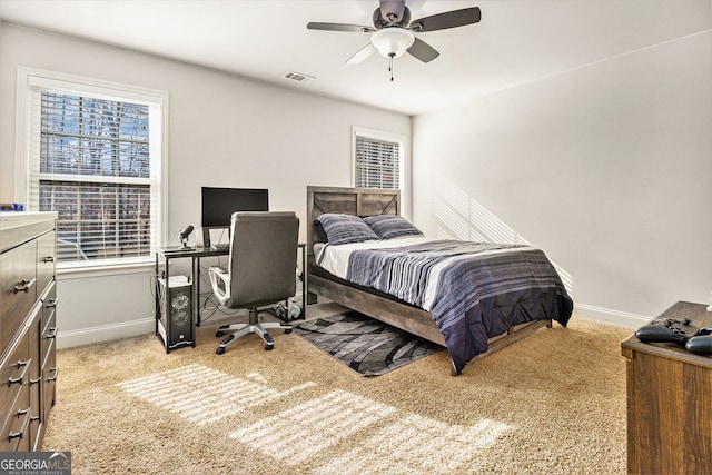 bedroom with light carpet, visible vents, and baseboards