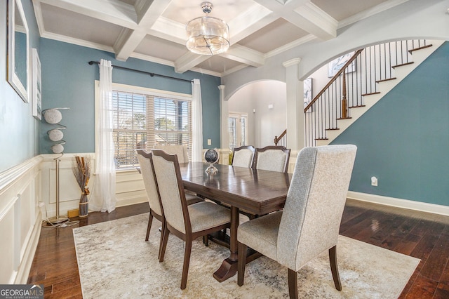 dining area featuring a notable chandelier, arched walkways, dark wood-style flooring, and beamed ceiling