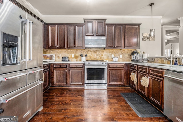 224 Jester Ct, Mcdonough, GA 30252 - kitchen featuring dark wood-style flooring, light countertops, ventilation hood, ornamental molding, and stainless steel appliances