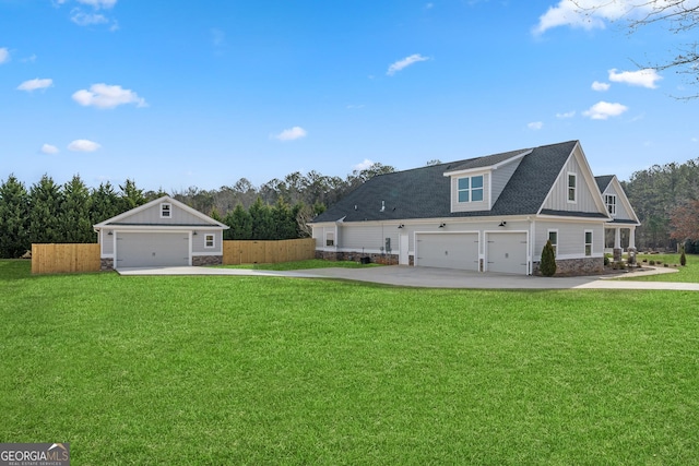 exterior space featuring board and batten siding, a garage, fence, and a lawn