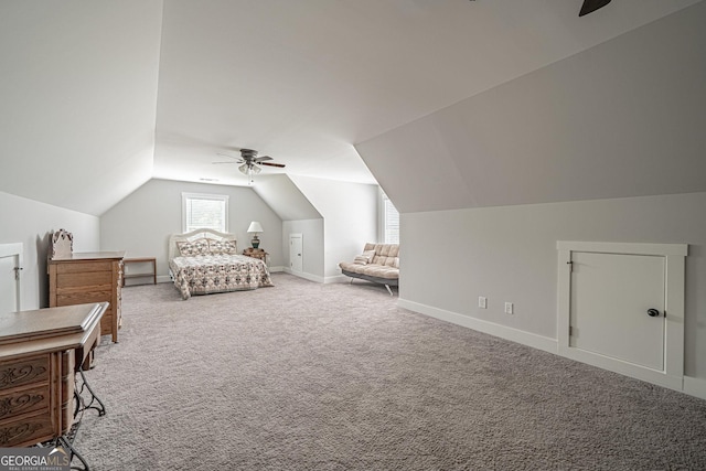 unfurnished bedroom with carpet floors, lofted ceiling, baseboards, and a ceiling fan