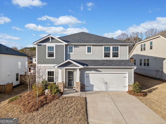 craftsman-style home featuring a garage, stone siding, driveway, and a shingled roof