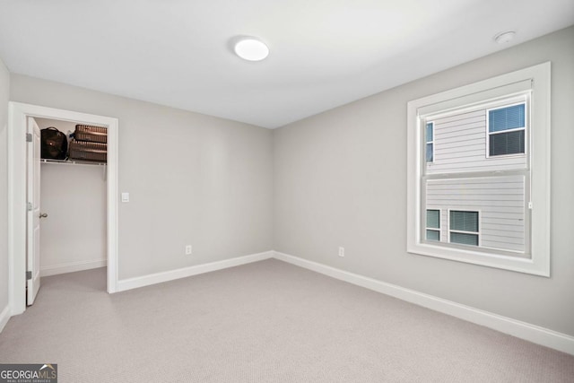 unfurnished bedroom with carpet flooring and baseboards