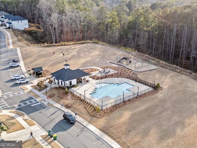 birds eye view of property featuring a wooded view