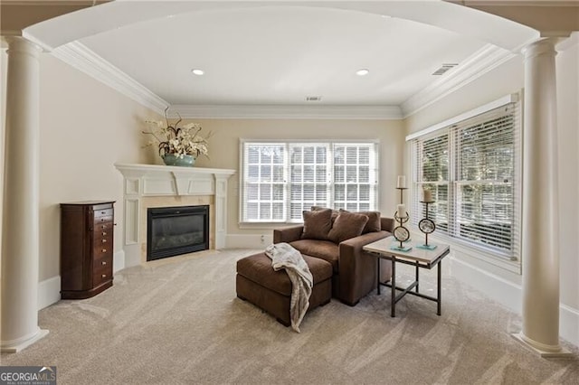 living room with a wealth of natural light, ornate columns, and ornamental molding