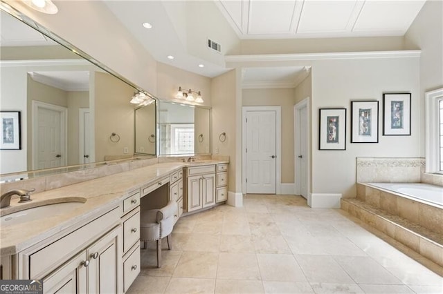 bathroom featuring ornamental molding, vanity, a relaxing tiled tub, and tile patterned floors