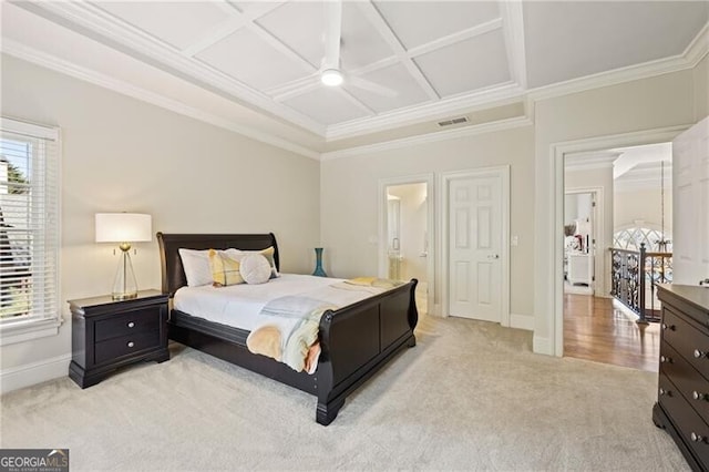 carpeted bedroom with ornamental molding, multiple windows, and coffered ceiling