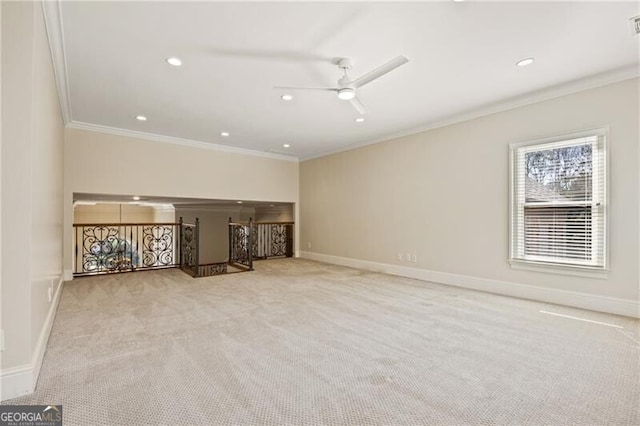 unfurnished living room featuring ceiling fan, crown molding, and light colored carpet