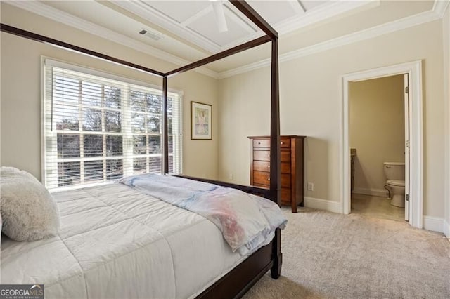 carpeted bedroom with crown molding and connected bathroom