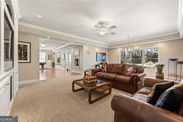 living room with ceiling fan with notable chandelier, crown molding, and light colored carpet