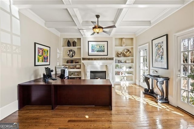 office area featuring beam ceiling, ceiling fan, coffered ceiling, hardwood / wood-style floors, and built in features