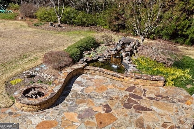 view of patio / terrace featuring an outdoor fire pit