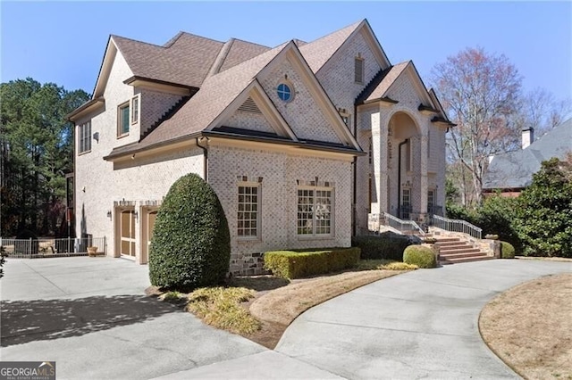 french country style house with a garage