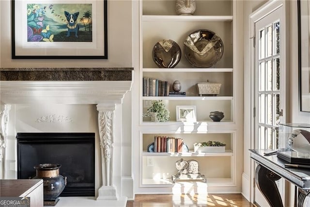 interior details featuring built in shelves and decorative columns