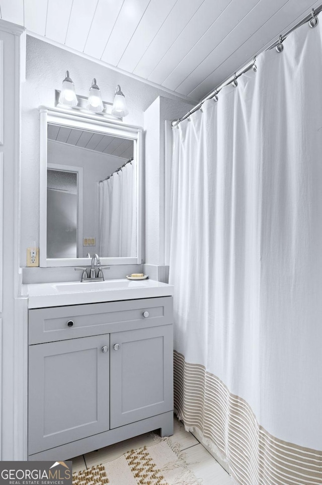 bathroom featuring wooden ceiling and vanity