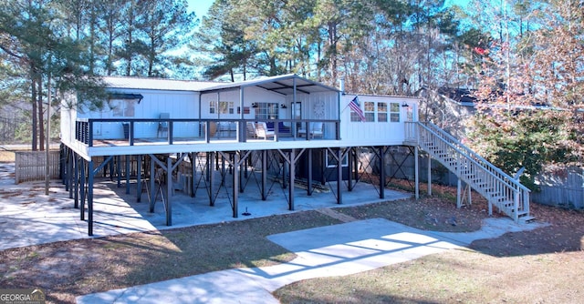 back of property featuring stairs, a patio, and a wooden deck