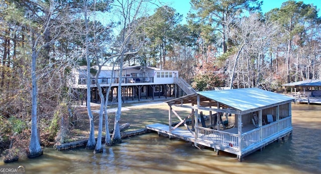 view of dock featuring stairway and a deck with water view