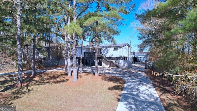 view of front of house with stairs and a wooden deck