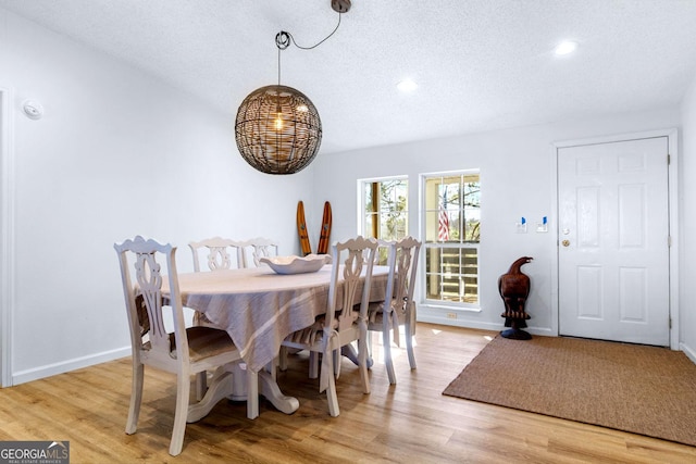 dining area featuring recessed lighting, baseboards, and light wood finished floors