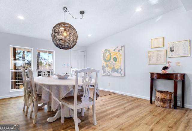 dining room featuring light wood-style floors, baseboards, and recessed lighting