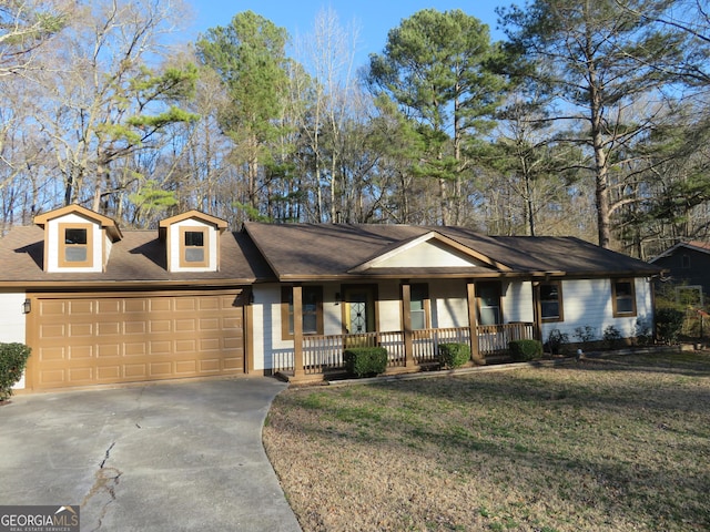 ranch-style home with an attached garage, covered porch, driveway, and a front lawn