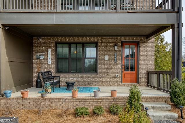 entrance to property with a patio and a balcony