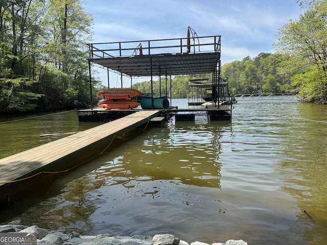 view of dock featuring a view of trees and a water view