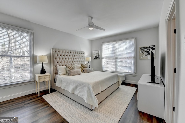 bedroom with ceiling fan, baseboards, and dark wood-type flooring