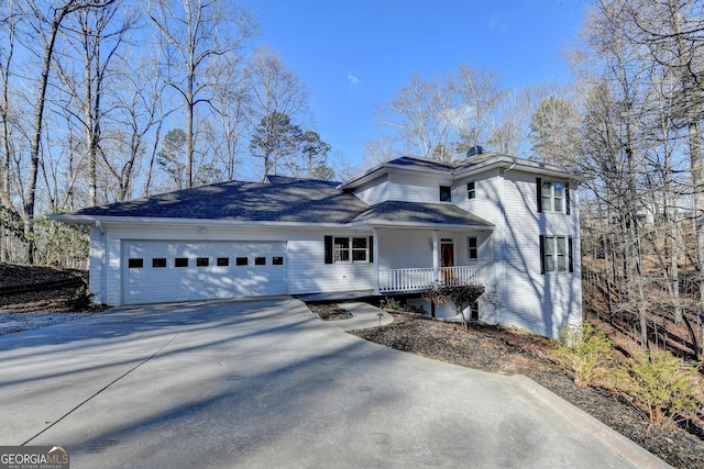 view of front of home with a garage, covered porch, and concrete driveway