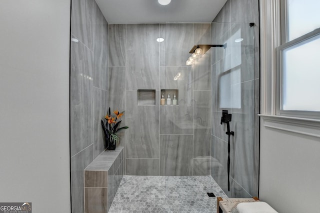 full bath featuring tiled shower
