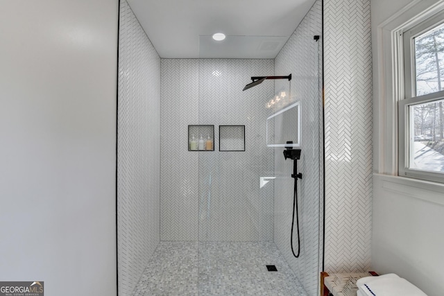 full bath featuring a tile shower